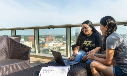 Students collaborating on terrace overlooking downtown Orlando